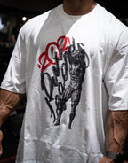 Model wearing oversized white graphic t-shirt with black and red muscle figure print