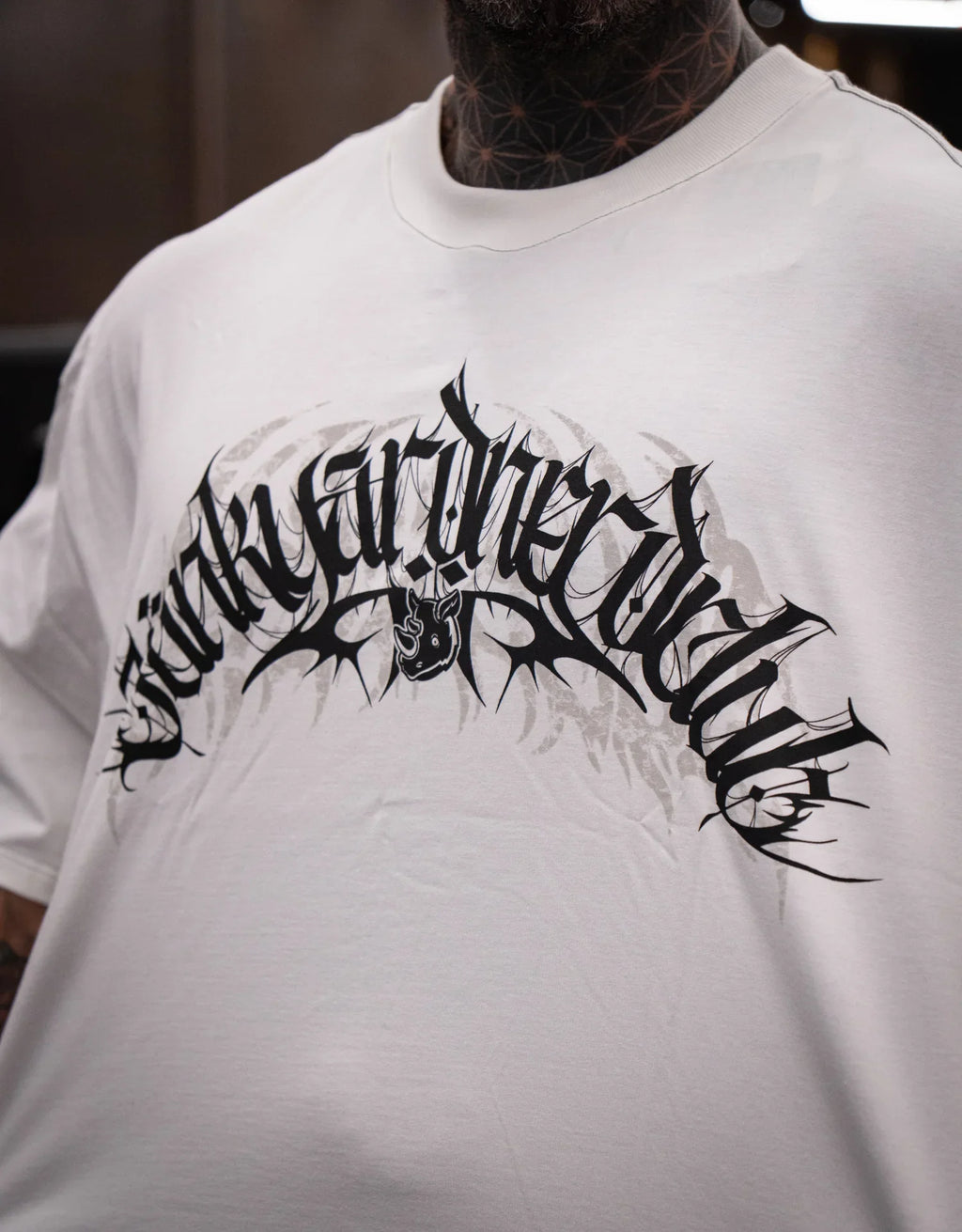 Model wearing graphic off-white t-shirt with bold black print design