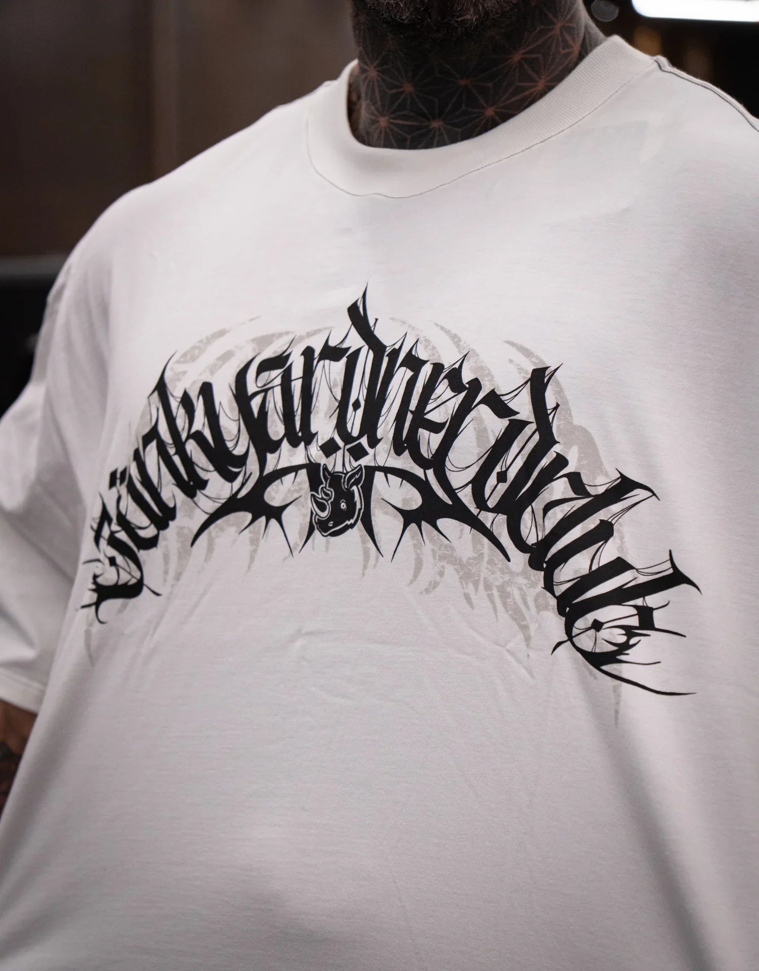 Model wearing graphic off-white t-shirt with bold black print design