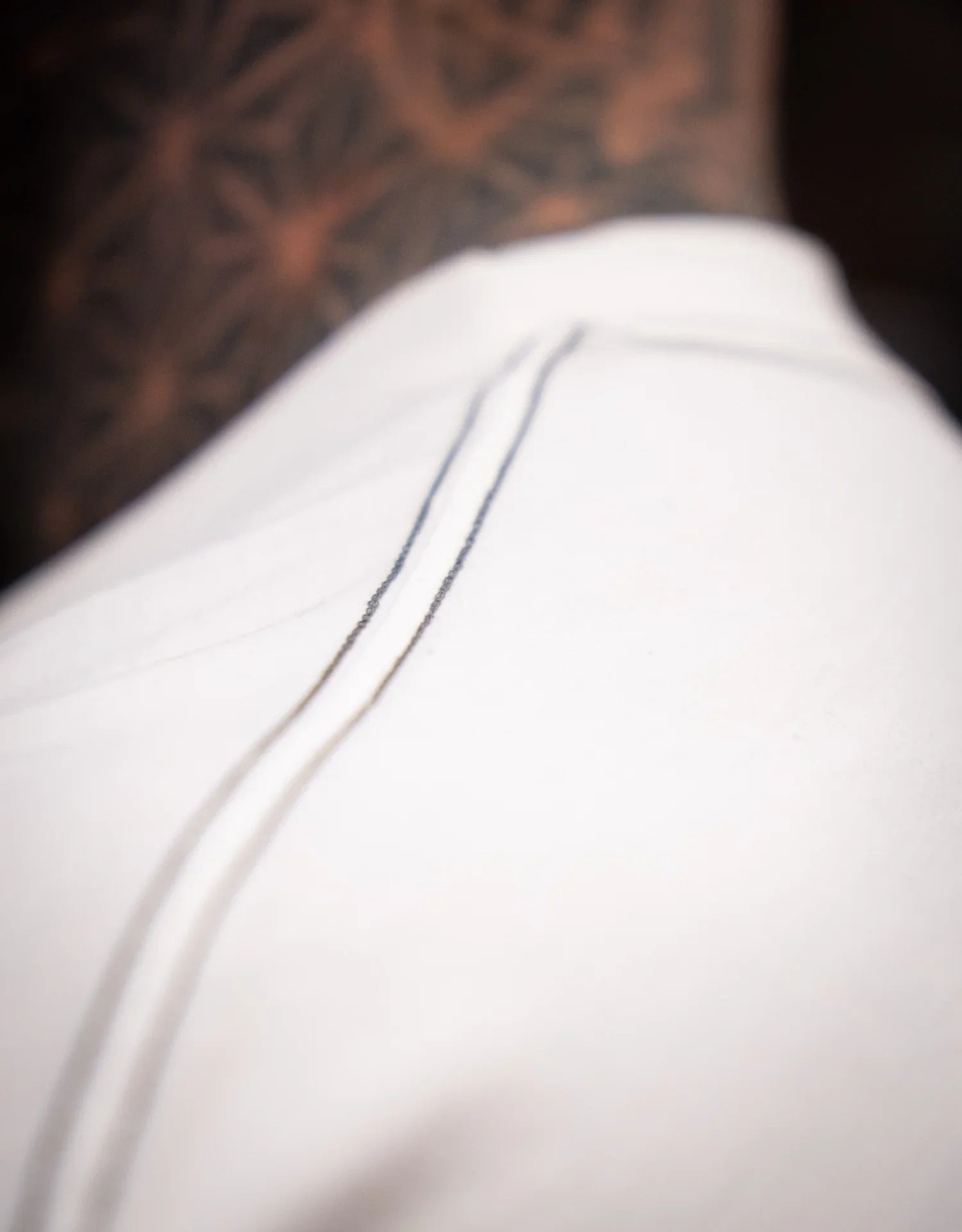 Close-up of model wearing off-white pants with visible seam detail