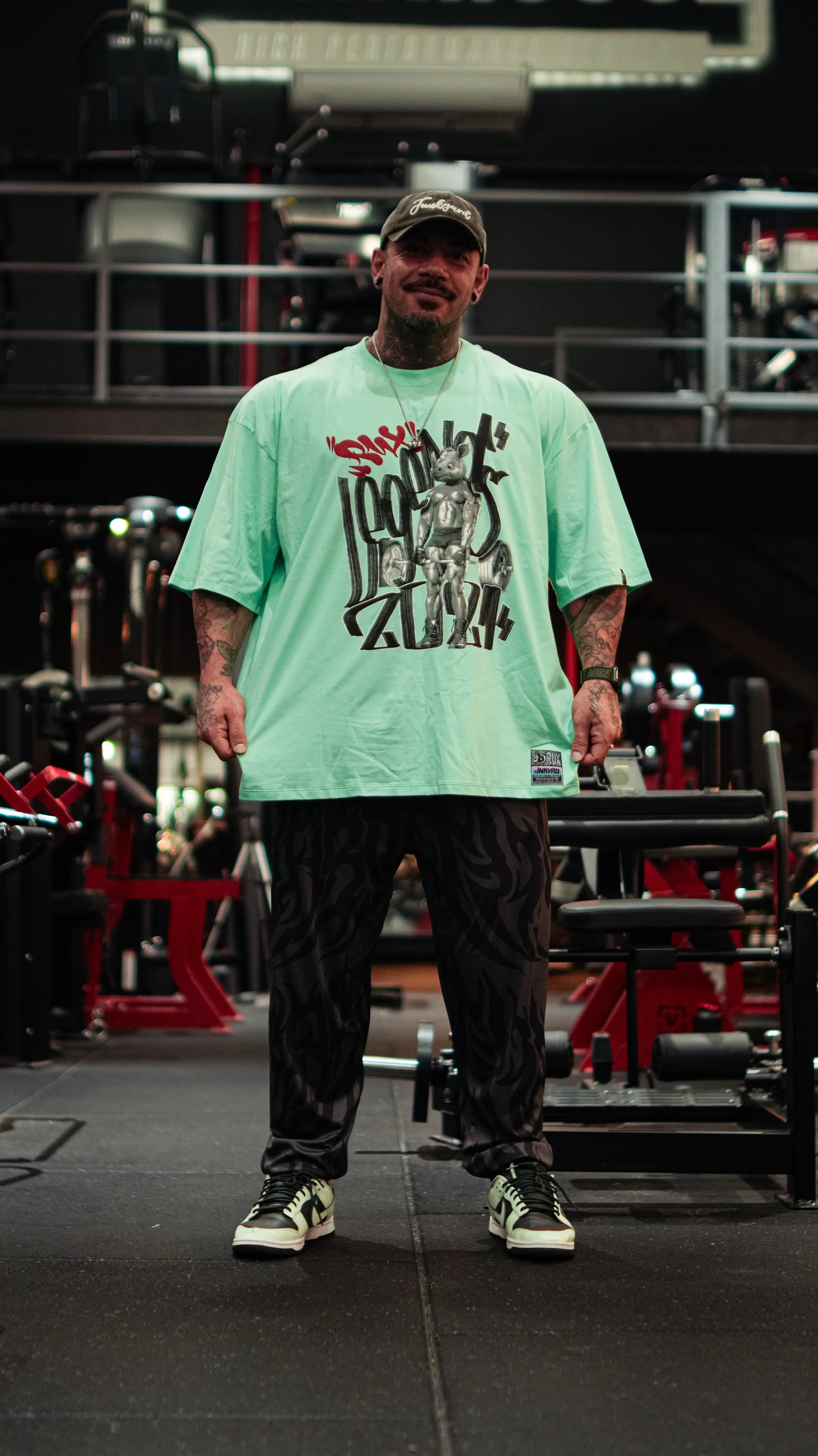 Model wearing patterned pants in a gym setting