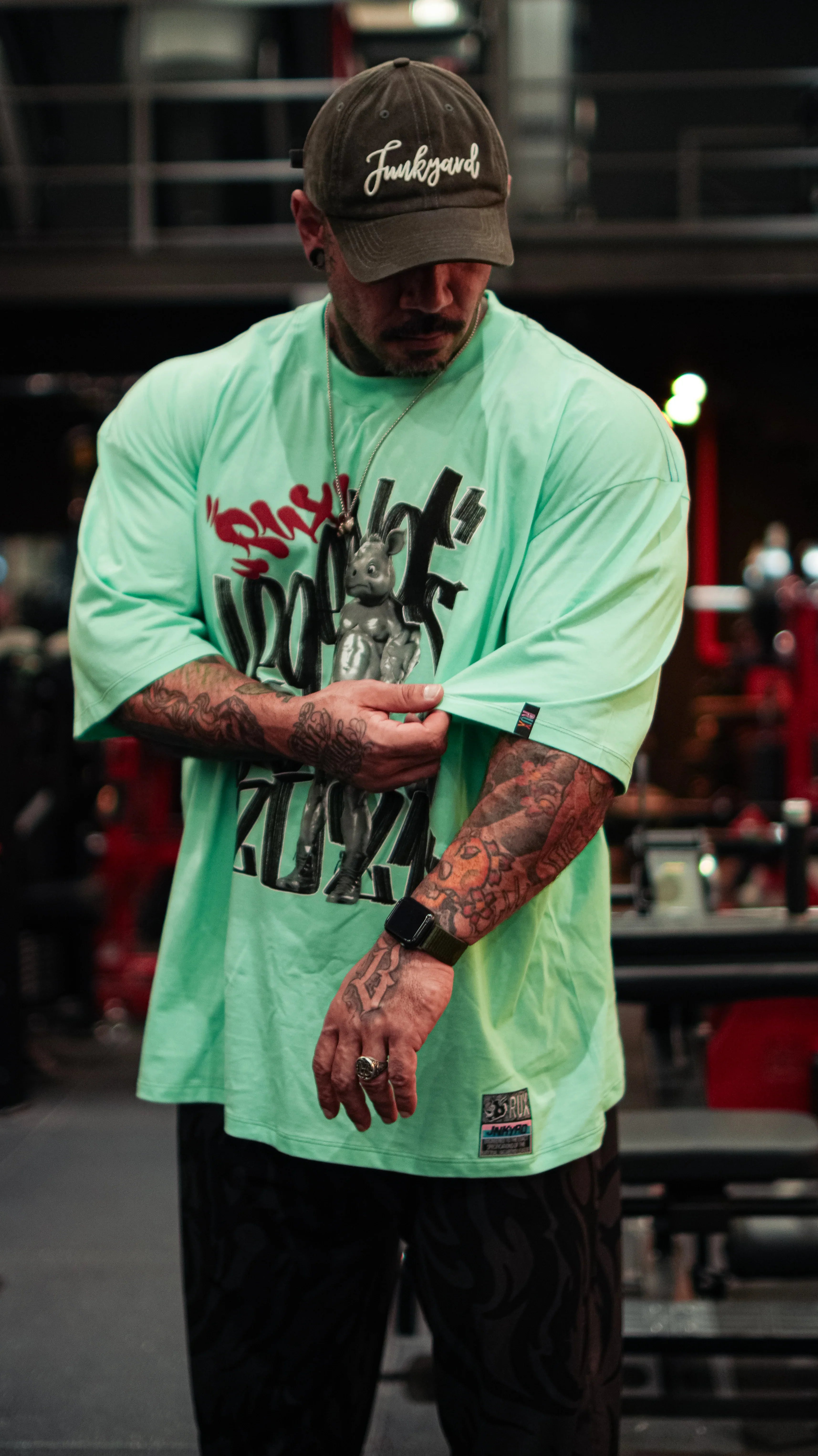 Model wearing casual black pants in gym setting, showing urban activewear style