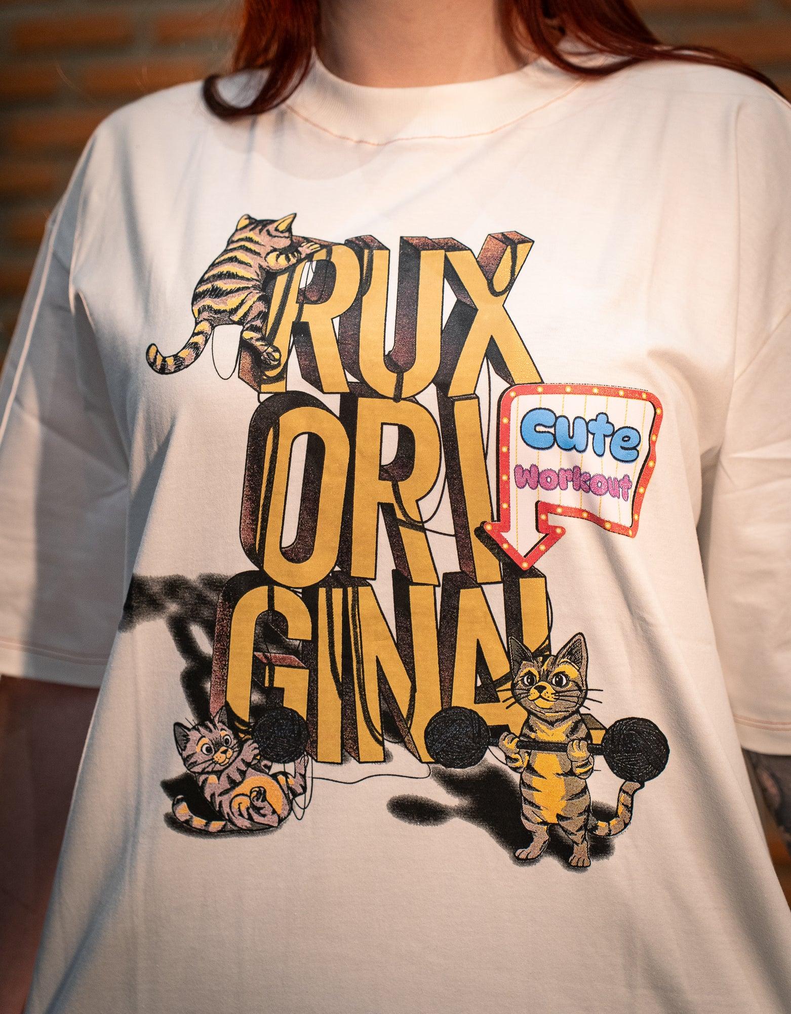 Model wearing a graphic tee with cartoon cats, bold text, and 'cute workout' speech bubble.