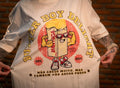 Model wearing graphic t-shirt with cartoon butter print and Portuguese text